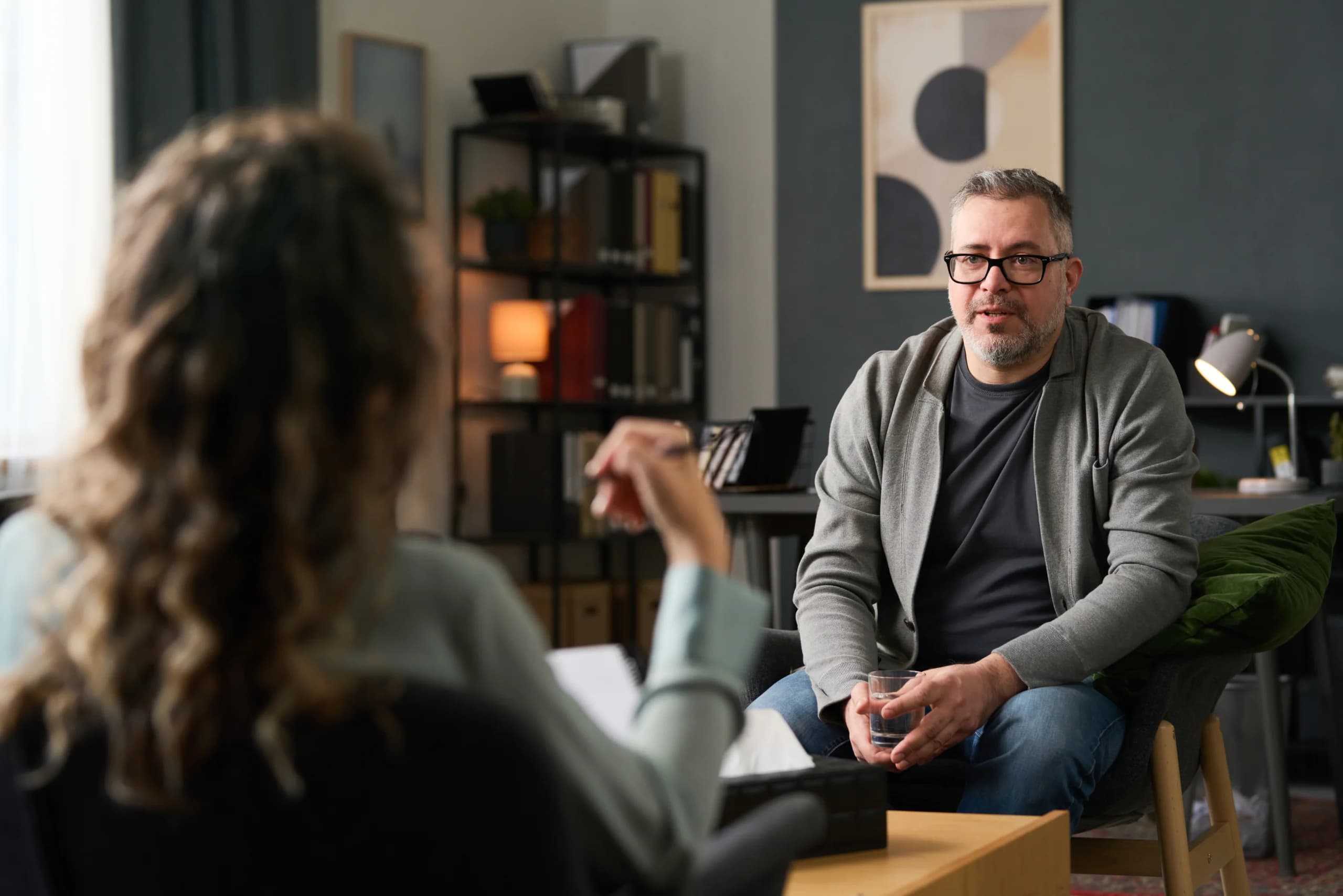 Two people talking in a comfortable counseling room