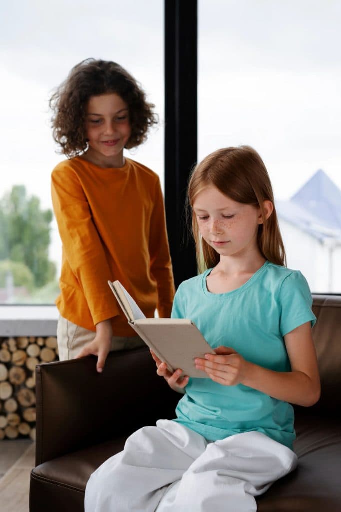 Two children looking at a tablet in a bright room